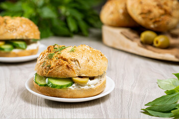 closed sandwich with fresh cucumber greens and olives