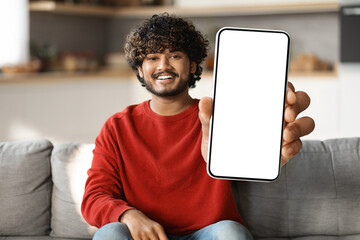 Mobile Ad. Smiling Indian Man Demonstrating Blank Smartphone With Big White Screen