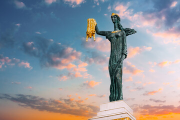 Batumi, Adjara, Georgia. Statue Of Medea On sunset sunrise Sky Background In Europe Square. Woman Holding Golden Fleece. In Greek Mythology, Medea Was Daughter Of King Aeetes Of Colchis And Wife To