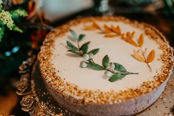 Shot of a colorful cake decorated with icing and sprinkles on a wooden surface