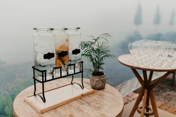 a table with glasses and bottles of drink sitting on it