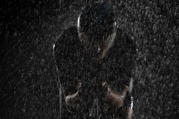 A triathlete braving the rain as he cycles through the night, preparing himself for the upcoming...