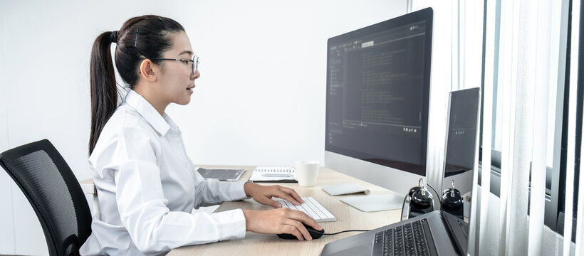 Women programmers working on website projects in software development on the desktop computer and making coding and typing data code password security in office