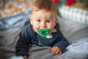 Fototapeta premium Portrait of cute happy baby boy looking at camera. Joy and happiness concept. Love and family emotion