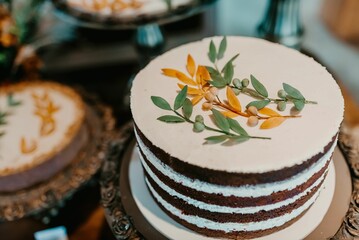a three tier cake with flowers on top sitting on a tray