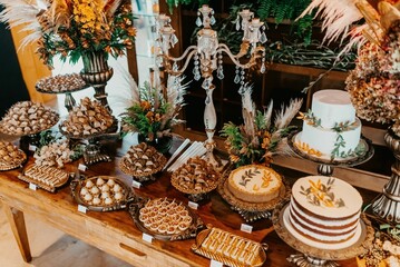 A closeup of a festive table with a variety of sweets and snacks served during the ceremony