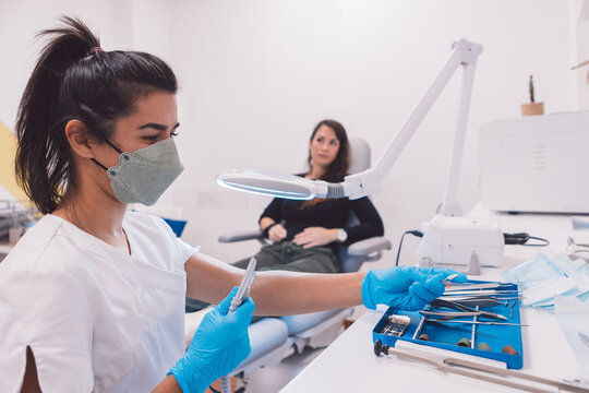 Concentrated podiatrist choosing instruments for procedure
