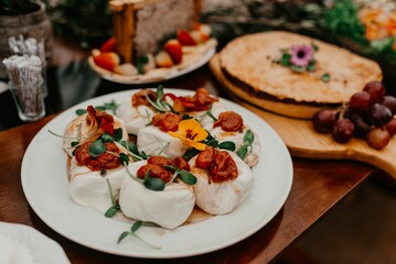 a table topped with food and fruit on it, which include two pizzas