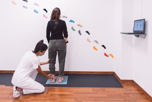 Concentrated podiatrist measuring foot of client during appointment