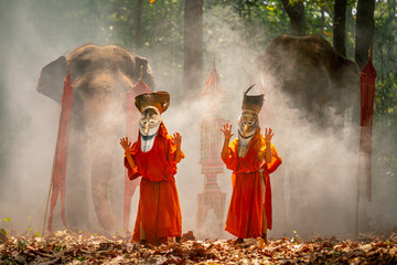 Two boy wear Pee Ta Khon, traditional culture art as ghost of Asian culture, dress and action to...