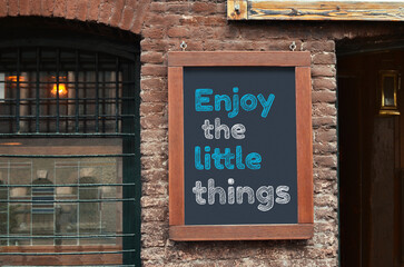 Inspirational vibes. Board with phrase Enjoy Little Things on building