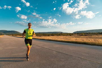 Triathlete in professional gear running early in the morning, preparing for a marathon, dedication...