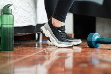 detailed view of the feet of a young latina woman modeling her workout sneakers