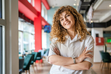 Portrait of one caucasian woman stand happy confident at cafe indoor