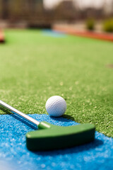 Mini-golf ball on artificial grass. Summer season game