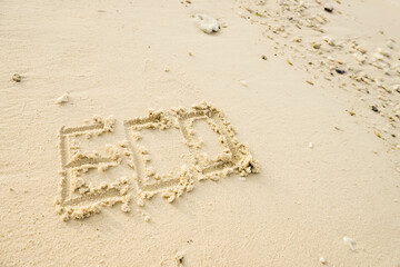 The word ECO is writting on the sand. drawing on the sand. writing with sands on the beach.
