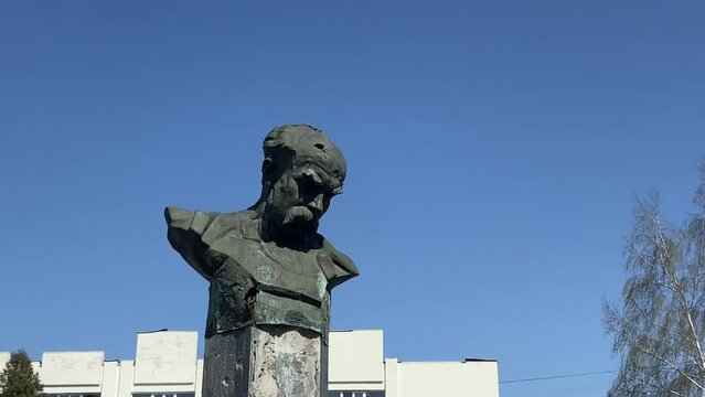 A monument to Taras Shevchenko in the city of Borodyanka, shot through with bullets. The monument mutilated by the Russians in Borodyanka. Sunny day. High quality 4k footage
