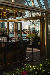 a restaurant that has glass on the outside of it with an outside dining area and