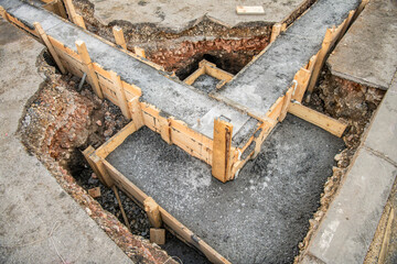 Construction pit with foundations lined with wooden boards