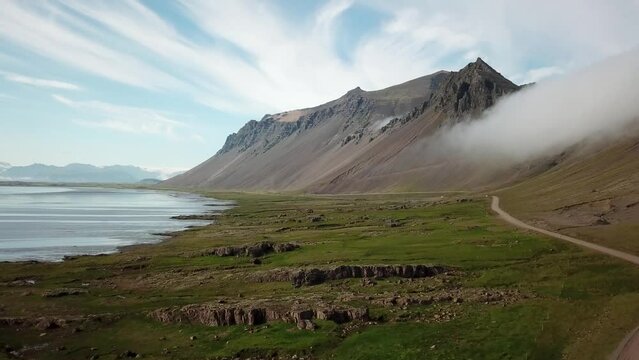 4K cinematic Aerial drone footage of Vestrahorn in Stokksnes. Iceland landscape with stunning mountains hidden in the mist. High quality 4k footage