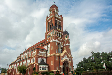 The historic Dutch Romanesque Revival style Cathedral of Saint John the Evangelist or La Cathedrale St-Jean built in 1916 on Cathedral Street in downtown Lafayette, Louisiana, USA - obrazy, fototapety, plakaty