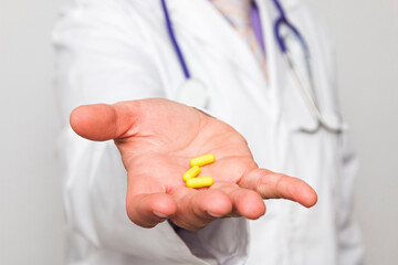 Close up of a doctor's hand with pills