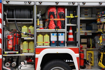 Inner compartment of fire truck with equipment - firehoses, fire extinguishers, cones, fire engine...