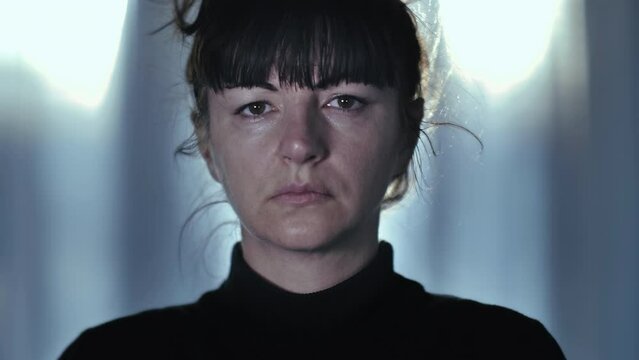 Portrait of tired woman looking at camera with a sad expression