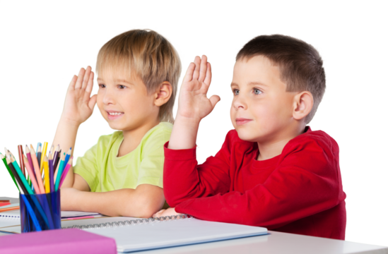 Group of school kids in classroom with hands raised