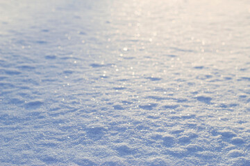 blurred snow surface with sunset warm light in winter evening