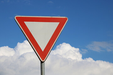 Traffic sign give way, the sky in the background