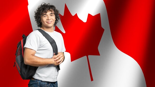 Happy Young Student Posing At Canada Flag