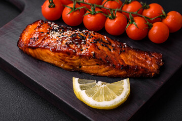 Delicious grilled red salmon fish with sauce, sesame seeds, spices and herbs