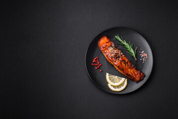 Delicious grilled red salmon fish with sauce, sesame seeds, spices and herbs