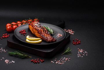 Delicious grilled red salmon fish with sauce, sesame seeds, spices and herbs