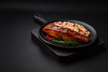 Delicious red salmon fish grilled with sauce and sesame seeds with rice and vegetables