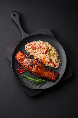 Delicious red salmon fish grilled with sauce and sesame seeds with rice and vegetables