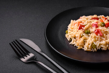 Delicious boiled rice with vegetables peppers, carrots, peas and asparagus beans