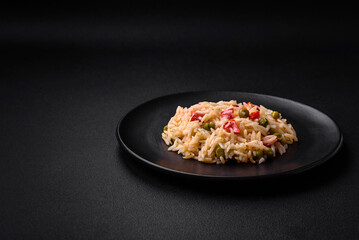 Delicious boiled rice with vegetables peppers, carrots, peas and asparagus beans