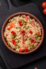 Delicious boiled rice with vegetables peppers, carrots, peas and asparagus beans
