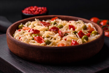 Delicious boiled rice with vegetables peppers, carrots, peas and asparagus beans