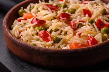 Delicious boiled rice with vegetables peppers, carrots, peas and asparagus beans