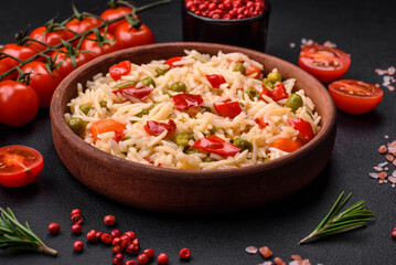 Delicious boiled rice with vegetables peppers, carrots, peas and asparagus beans