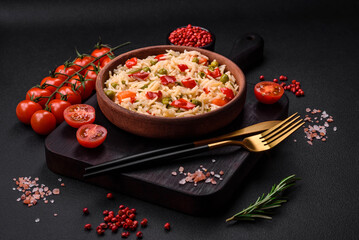 Delicious boiled rice with vegetables peppers, carrots, peas and asparagus beans