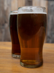 Brew. Closeup view of two beers, an amber ale and an ipa.