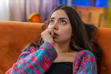 Sad lonely woman lying at home room looks pensive thinks over life concerns, unrequited love...