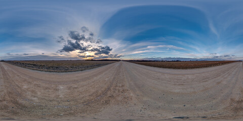 evening 360 hdri panorama on gravel road with stratus clouds on twilight blue sky before sunset in equirectangular spherical seamless projection, use as sky replacement in drone panoramas