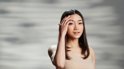 Beauty model doing uplifting campaign for self love, promoting natural skincare cosmetics on camera. Young woman being gentle and sensual, feeling confident about imperfections.