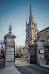 Fototapeta na wymiar Gate of entrance to peter's church in Drogheda, Ireland on a sunny morning in spring. Massive metal door in front of majestic church.