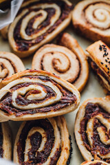 tray full of Kleicha, Iraqi date cookie in spiral form with nigella seeds	